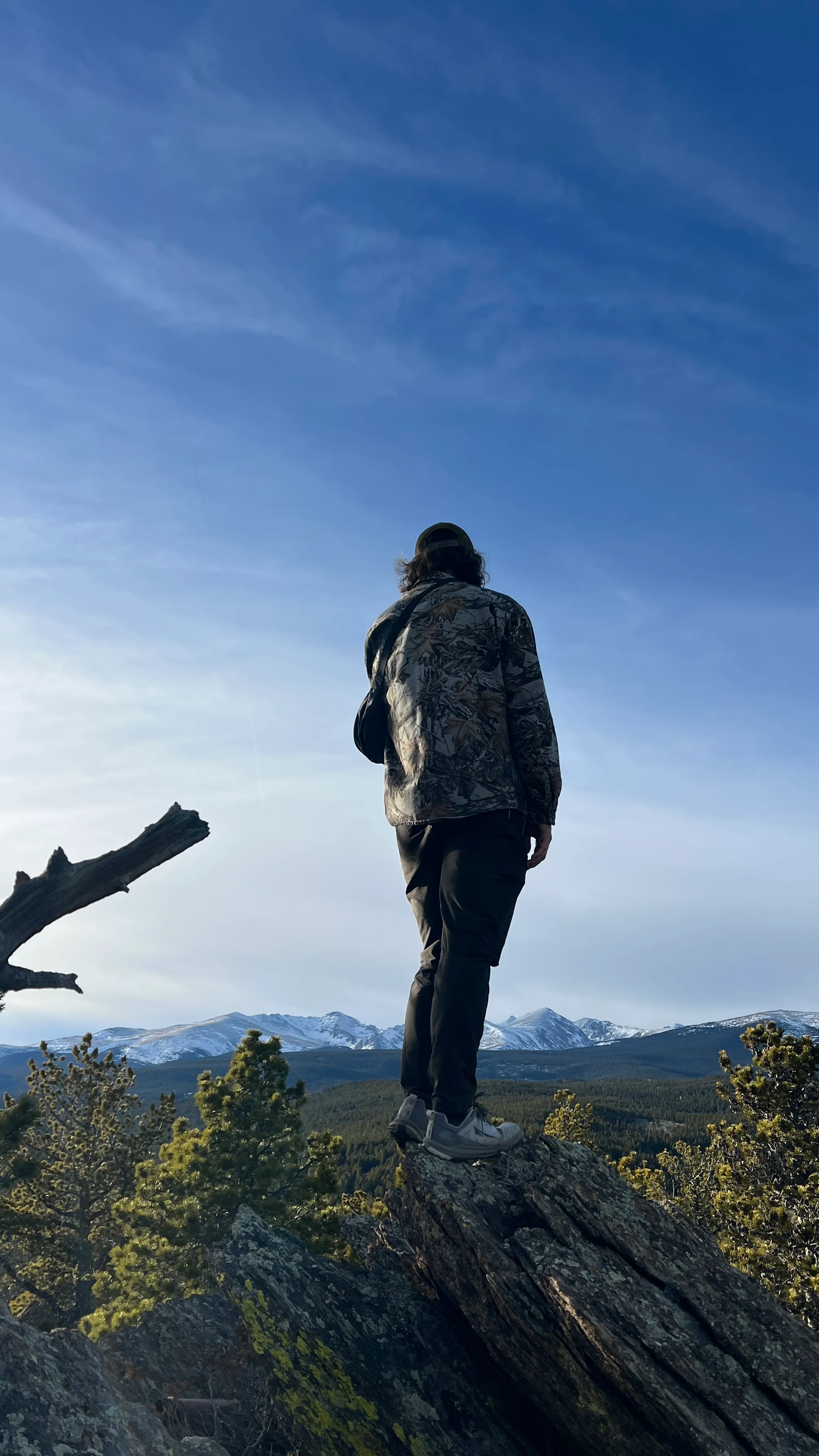 Austen Henry standing on a rock overlooking the Colorado Front Range